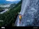 man-rock-climbing-on-squamish-chief-looking-at-camera-city-background-2BMBWA8.jpg